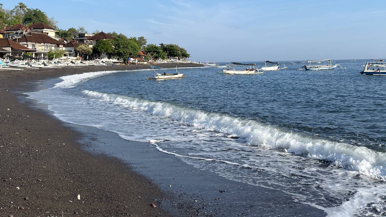 visiting black sand coastal amed, bali